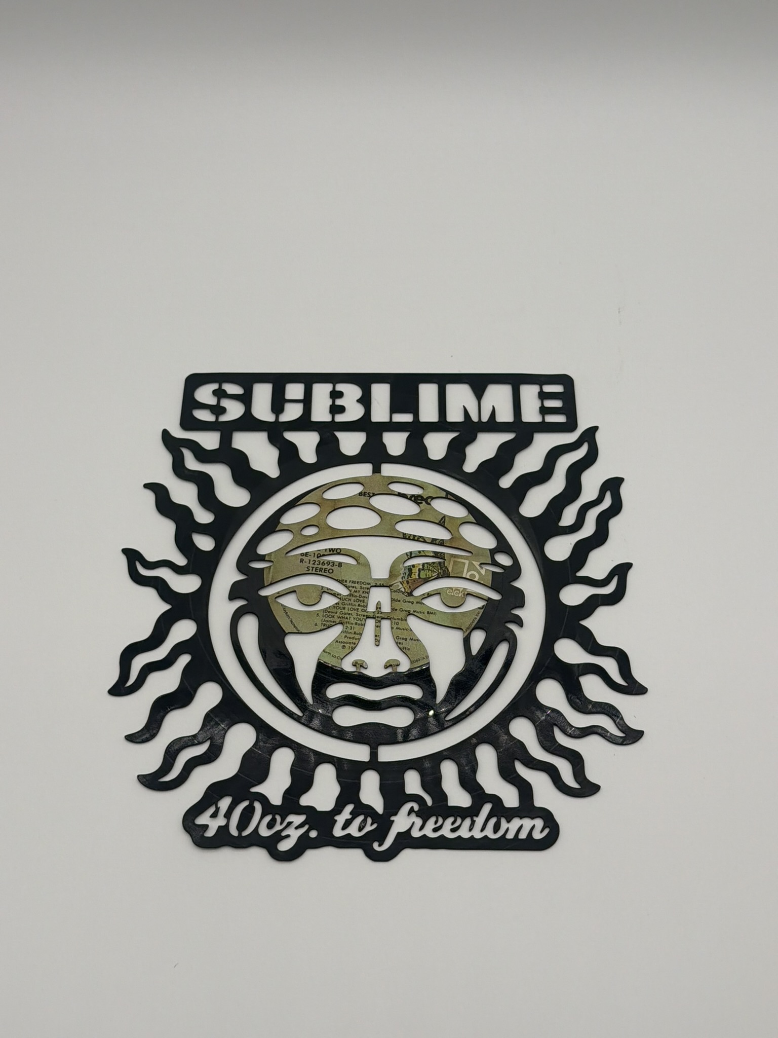 Laser-cut vinyl record with sun design